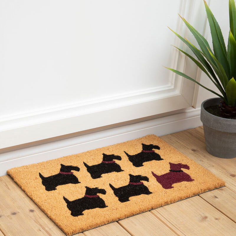 Coconut fiber filta scottie dog doormat with six black and one maroon scottie dog silhouettes wearing purple collars