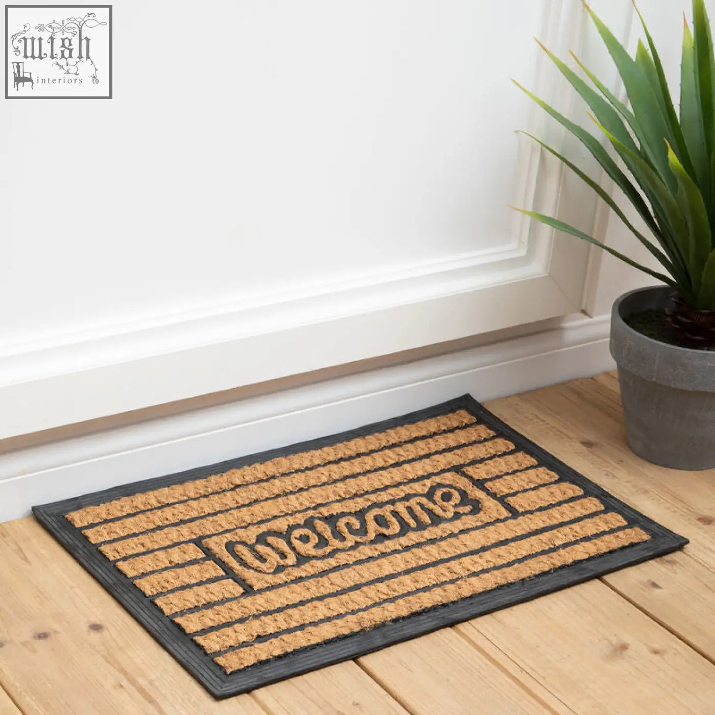 A rectangular brown coir panama doormat with skid pvc backing and welcome in raised dark lettering by filta