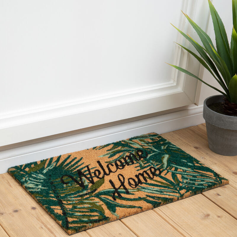 Filta winter palm doormat made of natural fiber with green and tan tropical leaves and welcome home embroidery