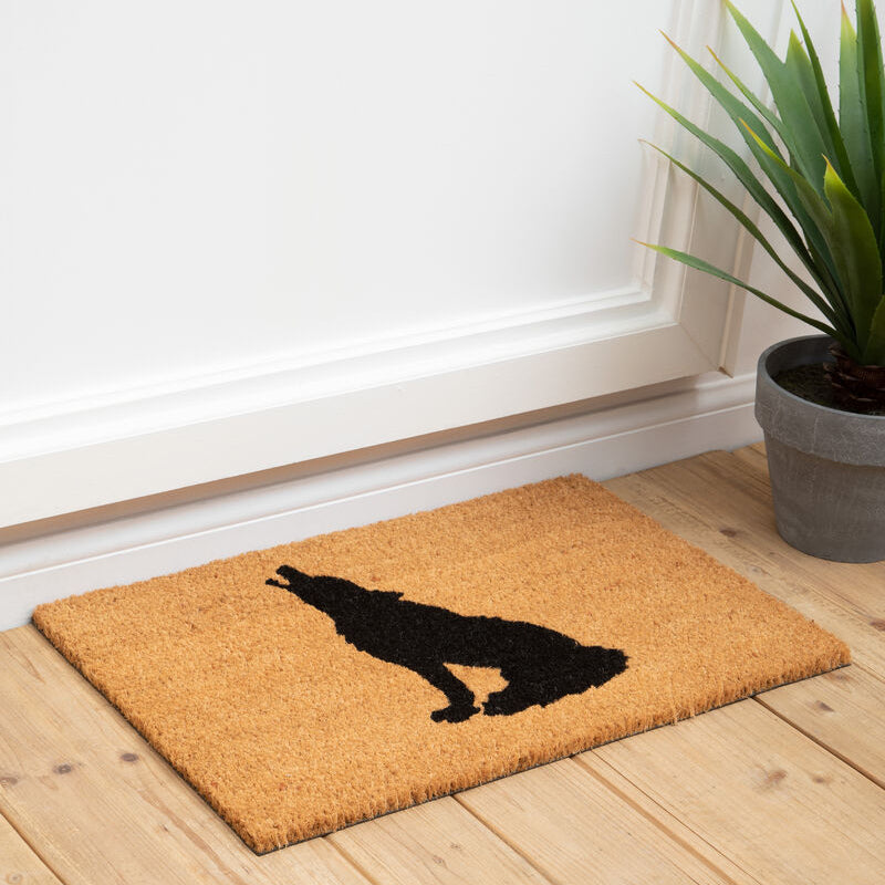 A tan coir filta wolf doormat with a bold black silhouette of a howling wolf perfect for entryways