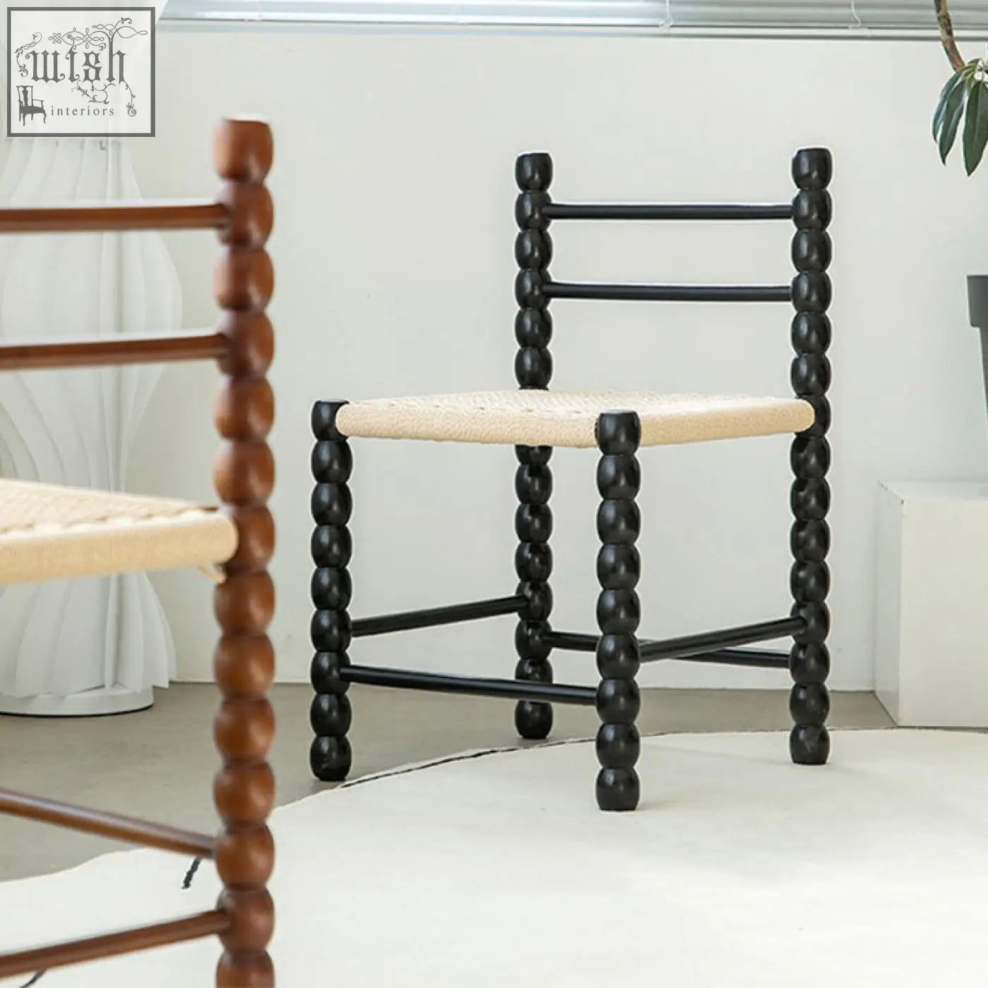 Black beaded ladder-back fiona dining chair with woven rattan seat perfect for stylish dining spaces