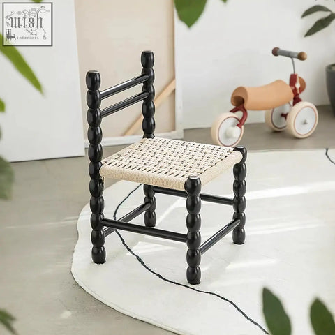 Black spindle-backed fiona dining chair with woven natural rattan seat perfect for cozy dining spaces