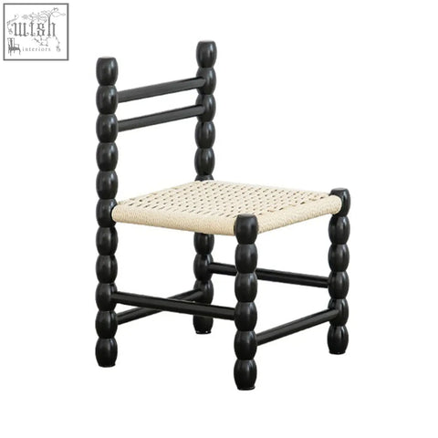 Black wooden fiona dining chair with woven beige rattan seat and bead-like turned legs for stylish dining use