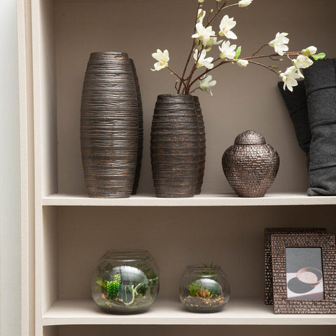 Two tall dark gray textured vases with ridges and a smaller metallic silver jar on the top shelf in fiori large terranium