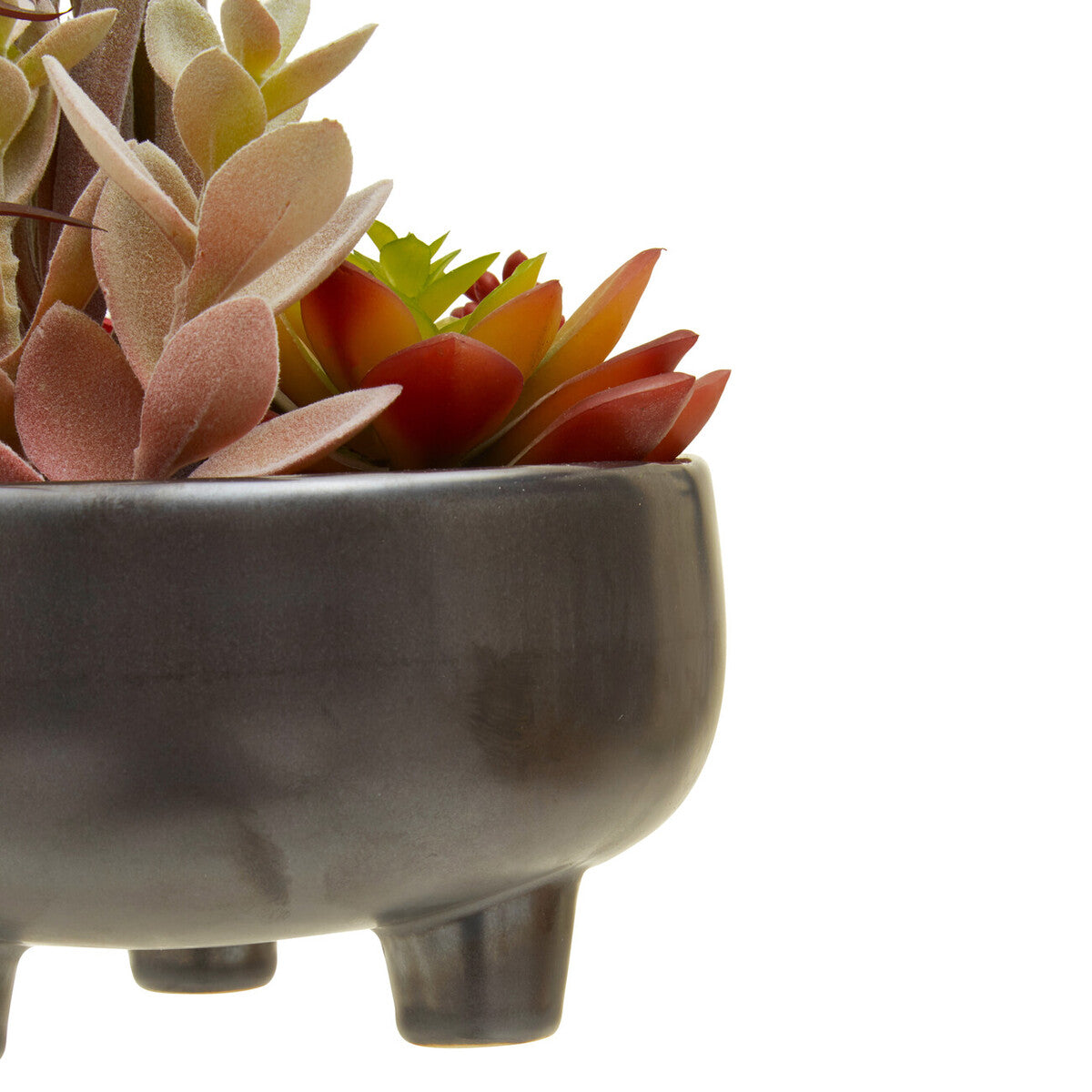 Dark gray ceramic pot with three legs holding pink and reddish-orange mixed succulents in grey ceramic planter