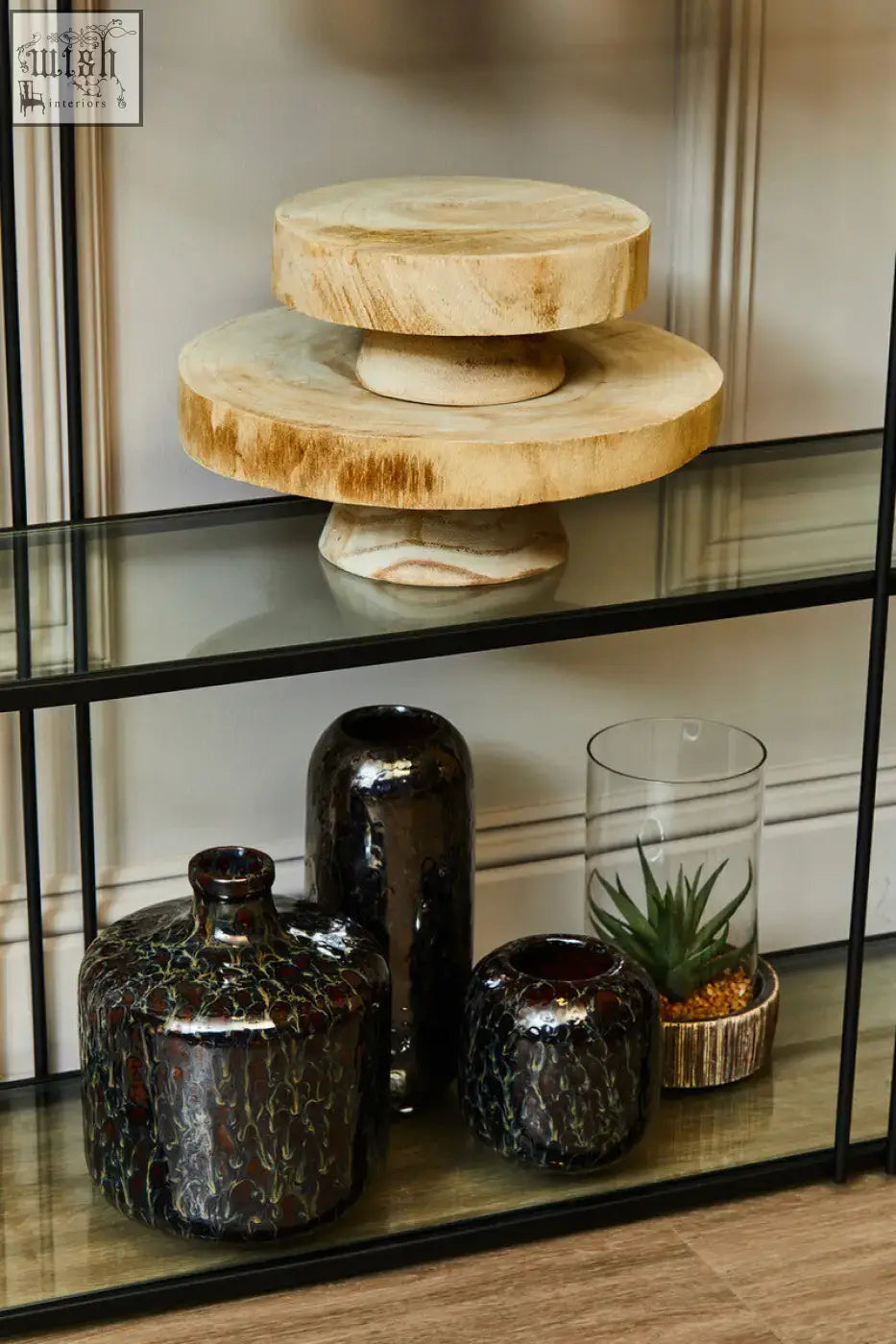 Natural wood cake stand with rustic circular design and visible grain on natural stone base for small succulents