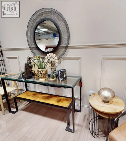 Circular wireframe mirror with black textured mesh design and natural stone base perfect for small succulent display