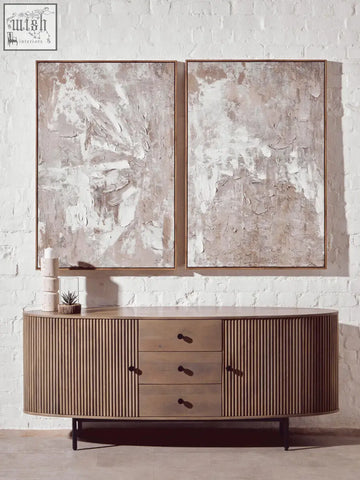 Modern wooden sideboard with vertical slats and dark metal legs next to fiori small succulent with natural stone base