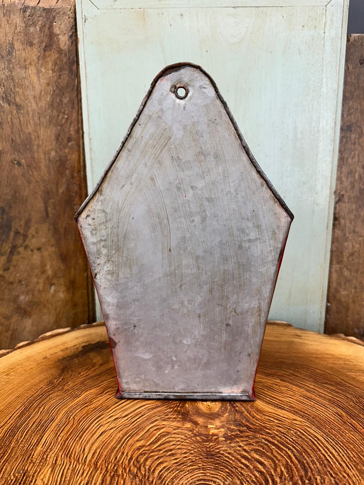 A weathered metallic enamel fire plant pot planter with faded red trim and aged silver-gray finish wall-mounted organizer