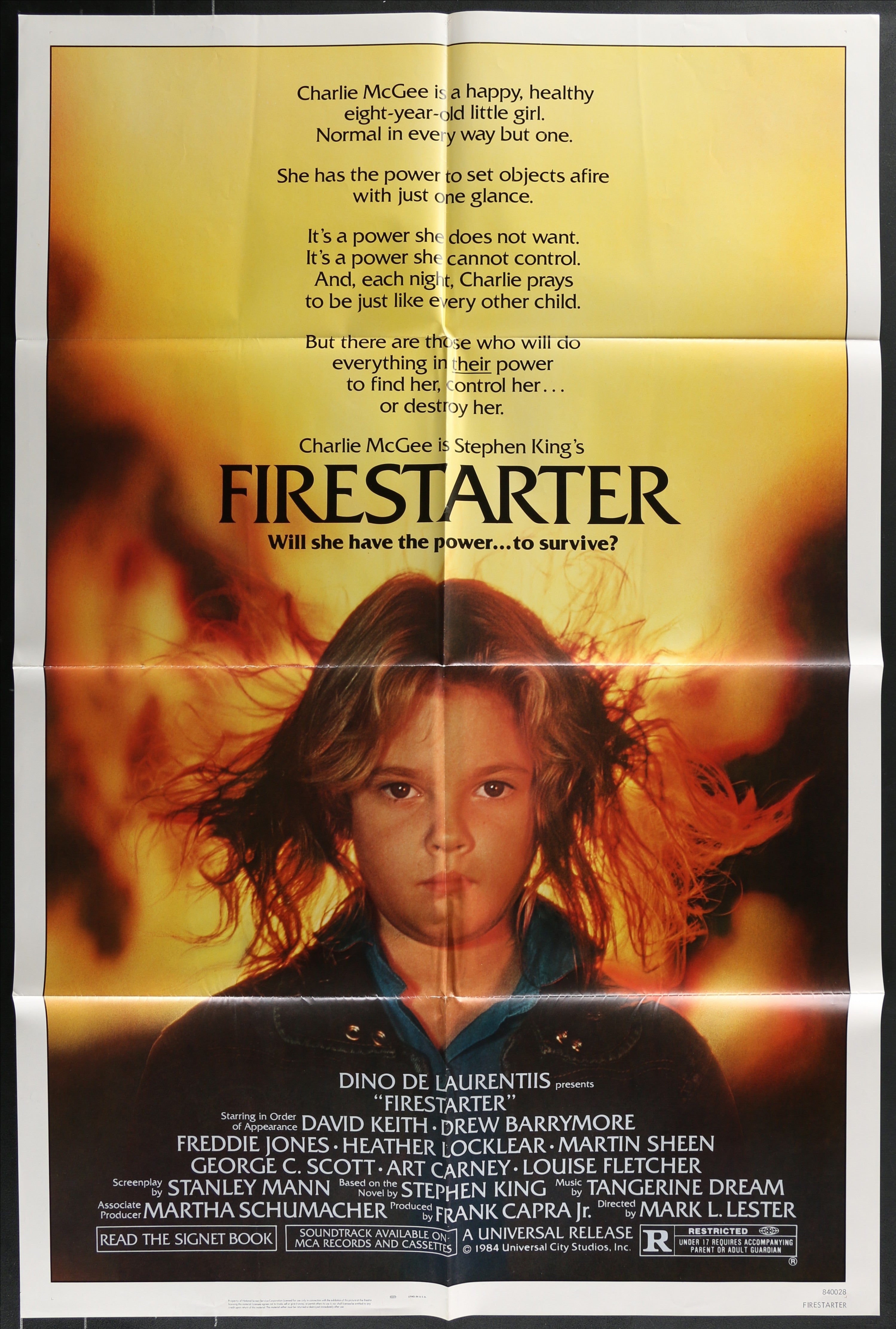 A fiery orange and yellow firestarter 1984 original us one sheet movie poster featuring a girl with flames
