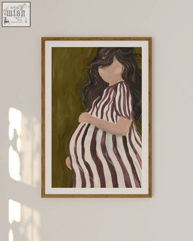A framed parenthood art print of a pregnant woman in a striped dress on an olive green background for home decor