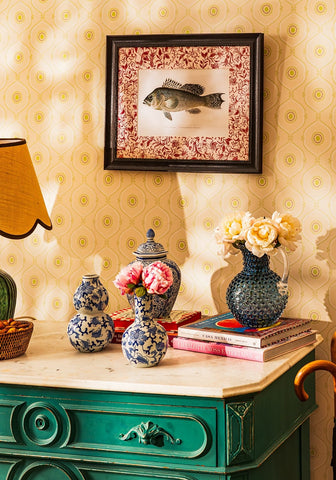 A textured dark blue ceramic vase with a glossy finish and ornate handle featured in fish iii framed print noble vintage for the english home