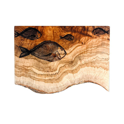 Natural olive wood chopping board with warm beige layered grain and black engraved fish design for rustic use