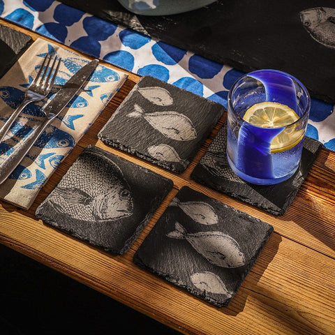 Black slate single slate coaster with engraved fish design perfect for stylish drink protection