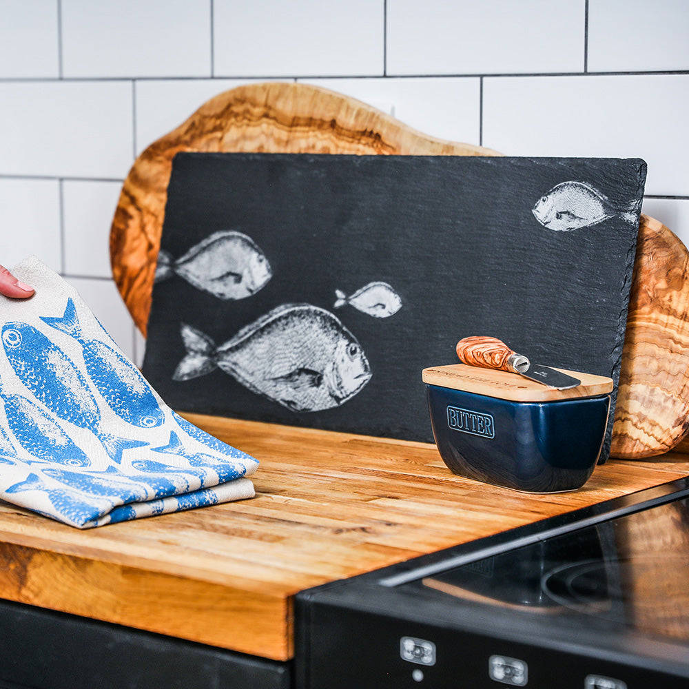 Navy blue ceramic butter dish with wooden lid and silver butter label on slate table runner table runner setup