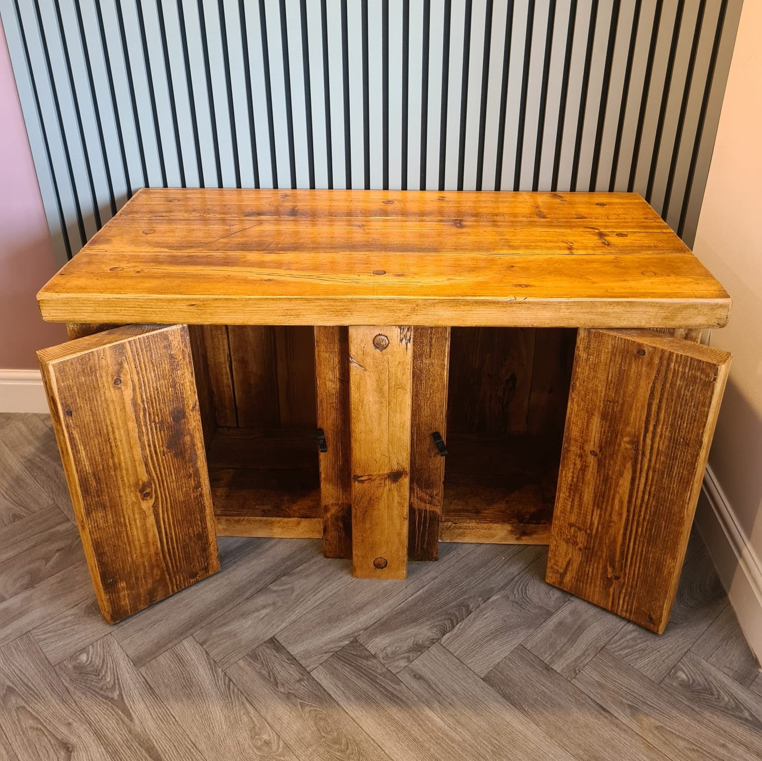 Rustic redwood fish tank stand with warm natural finish and two open cabinet doors for aquarium storage