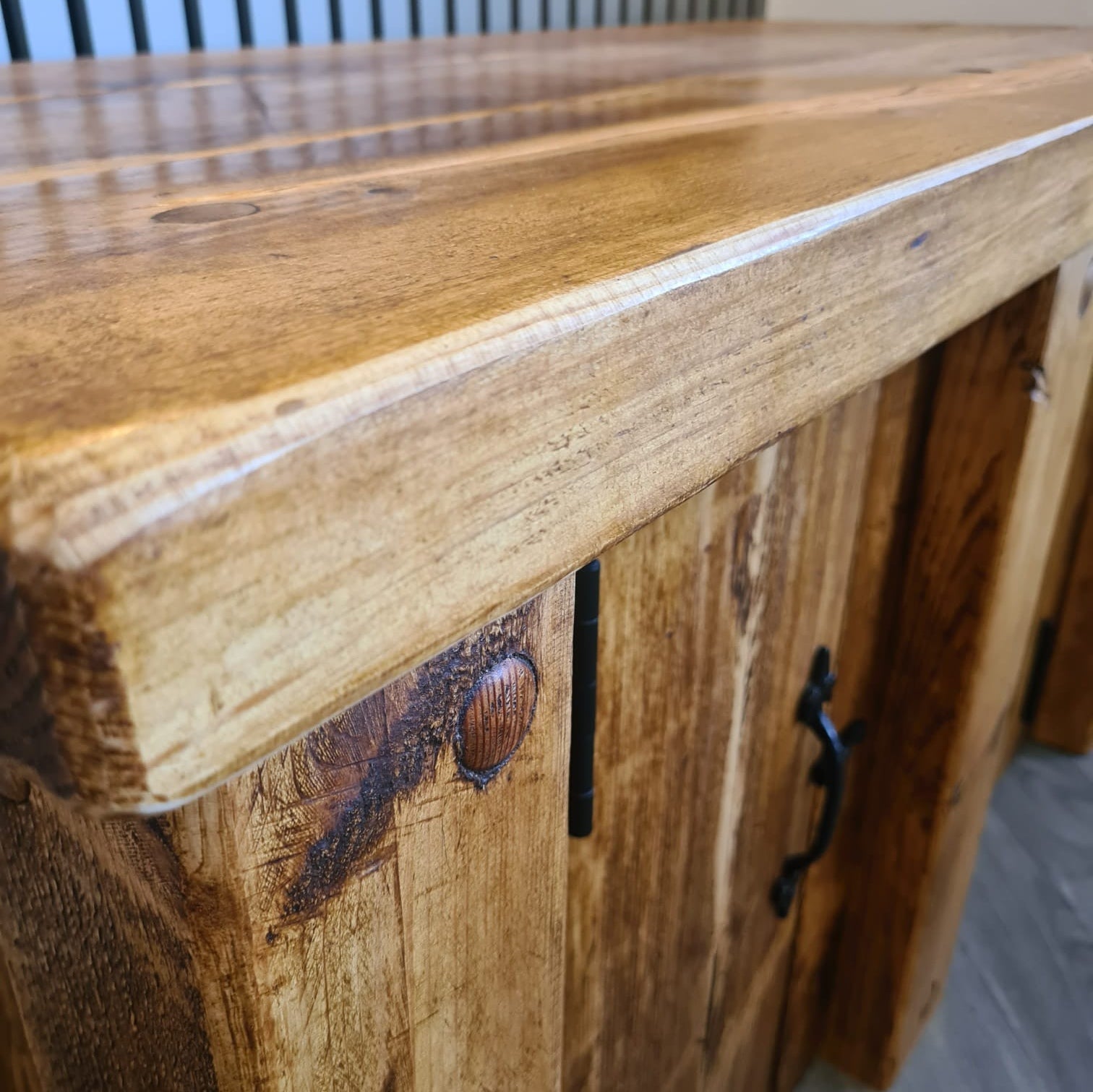 Rustic redwood fish tank stand with warm natural finish and dark metal hardware for aquarium storage