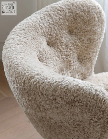Cream-colored plush fitz armchair made with long hair artificial wool perfect as a cozy lounge chair