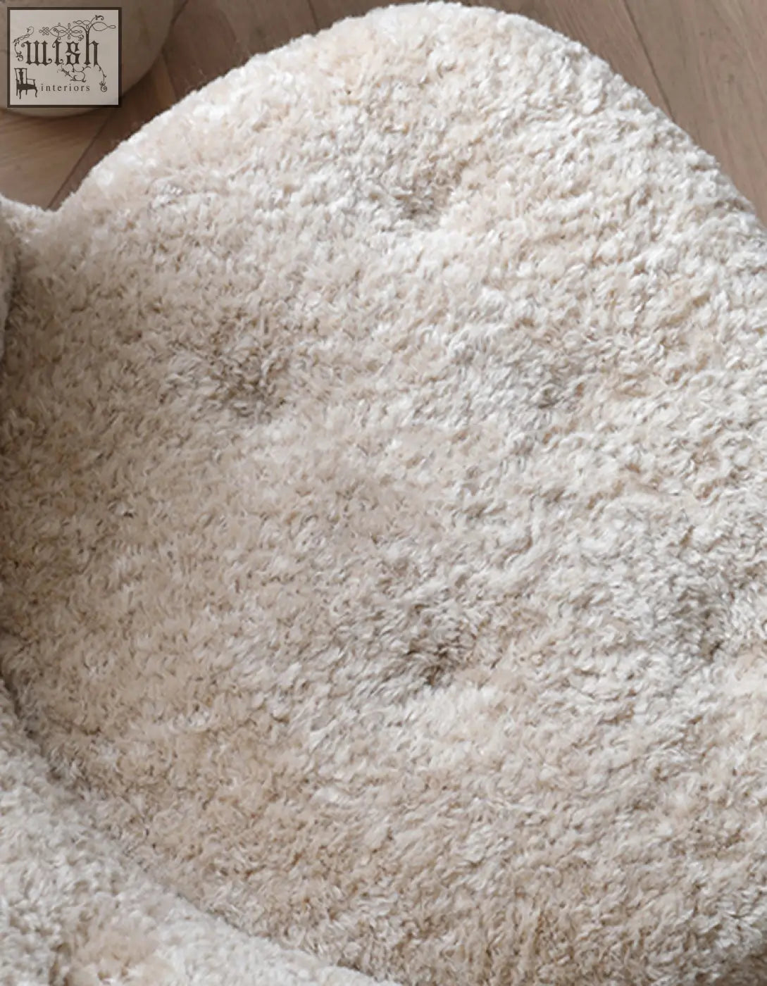 Cream-colored plush fitz armchair lounge chair with soft curly artificial wool and rounded edges for cozy pets