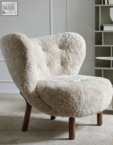 Cream-colored fitz armchair lounge chair with tufted artificial wool and dark wood legs for cozy seating