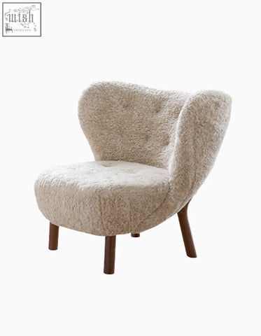 Cream-colored fitz armchair lounge chair with long hair artificial wool and tufted upholstery with dark wood legs