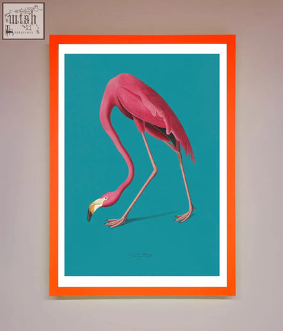 A vibrant pink flamingo walks blue framed print with a bold orange frame against a teal background