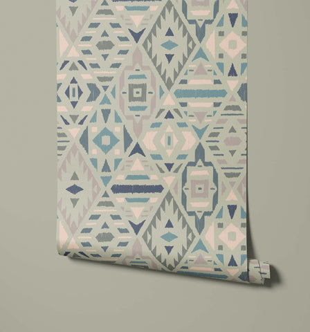 Fleece with a geometric patterned wallpaper design of triangles diamonds and abstract shapes in muted blue pink gray and beige