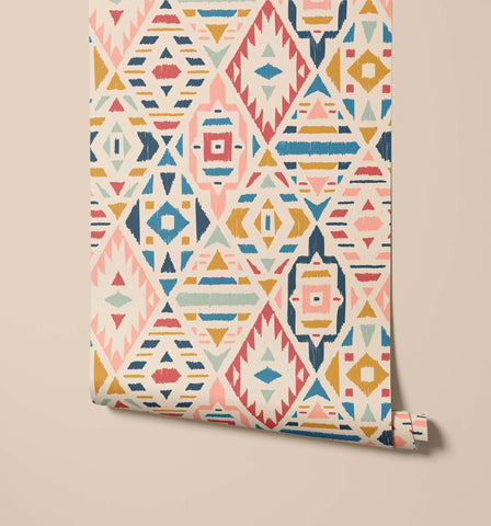A roll of fleece wallpaper with a vibrant geometric pattern in pink blue yellow and teal on off white background