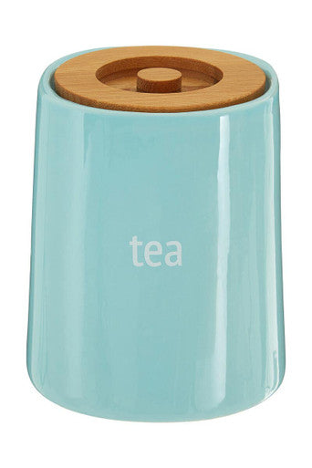 A sleek light blue ceramic tea canister with natural wood lid and tea print from fletcher blue ceramic tea series