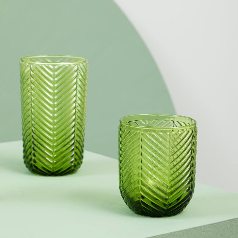 Two translucent green glass tumblers with textured chevron pattern from fleur set of four green tumblers