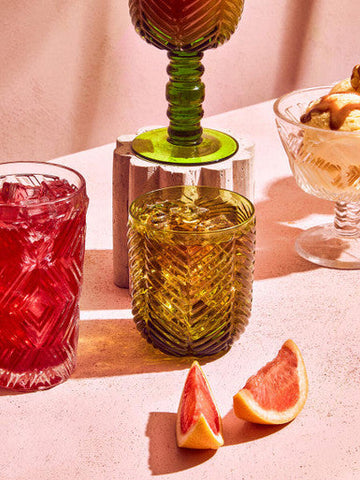 A vibrant golden-yellow glass tumbler from the fleur set featuring textured geometric etching and four green tumblers style