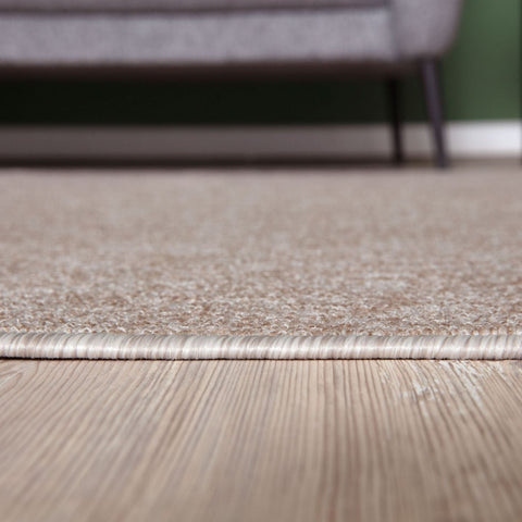 Beige low pile flex beige low textured area rug with subtle woven border perfect for modern spaces
