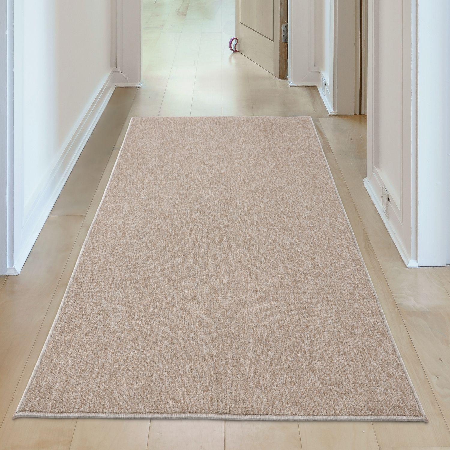 Beige low pile flex beige low textured runner rug with subtle woven pattern and neatly finished edges