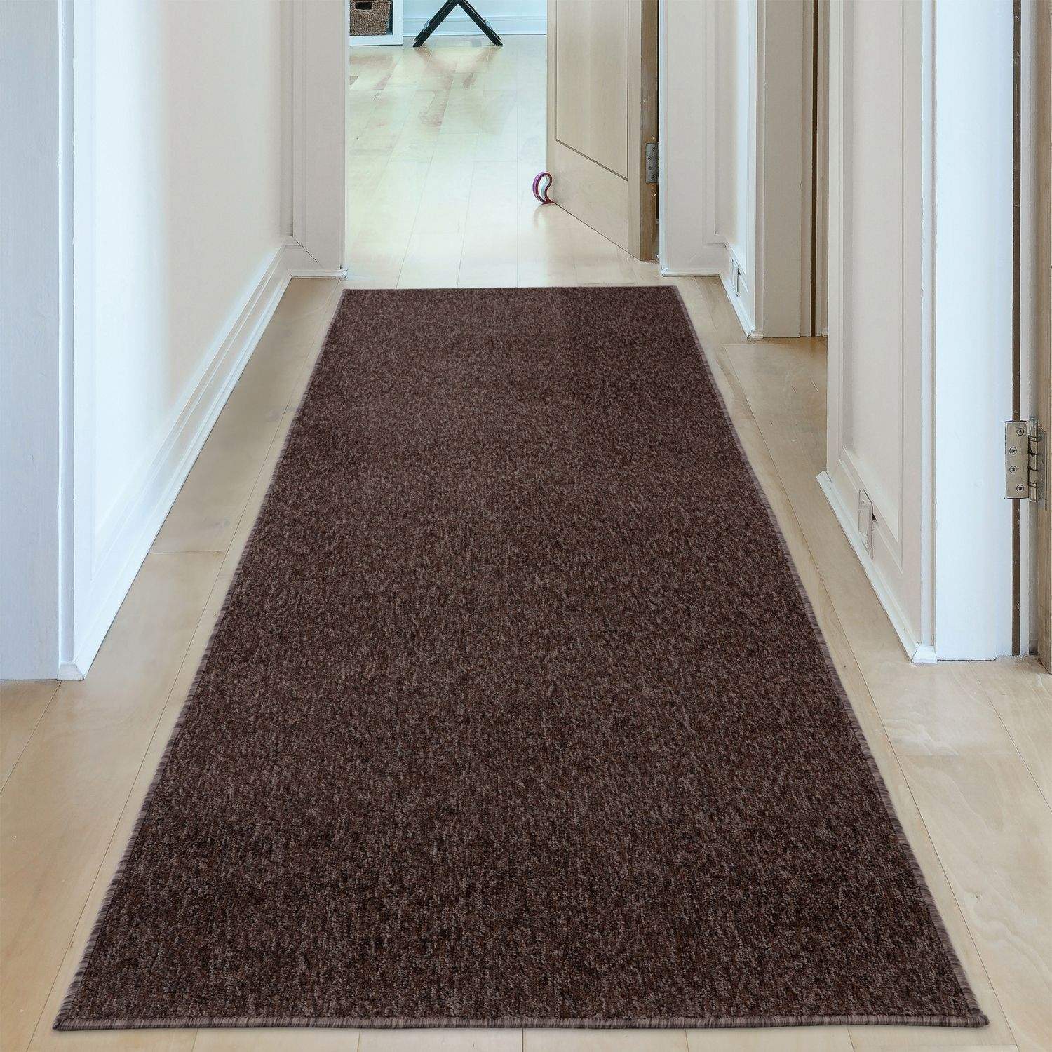 A plush flex brown low pile rectangular hallway rug with a textured looped pile finish in dark brown