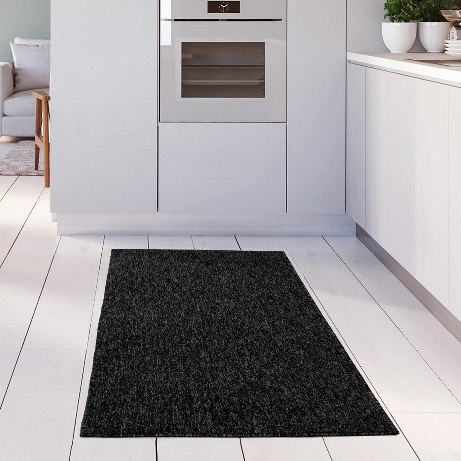 Black textured flex dark grey low pile solid rug with a soft, durable finish perfect for modern spaces