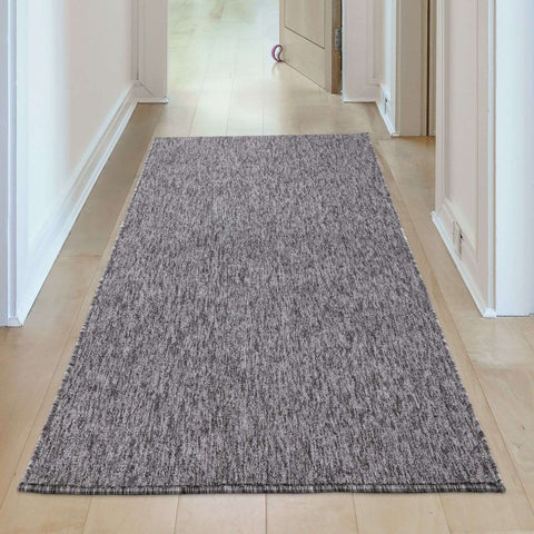 Gray low pile rug with subtle heathered flex grey low pattern and fringed edges for stylish floors