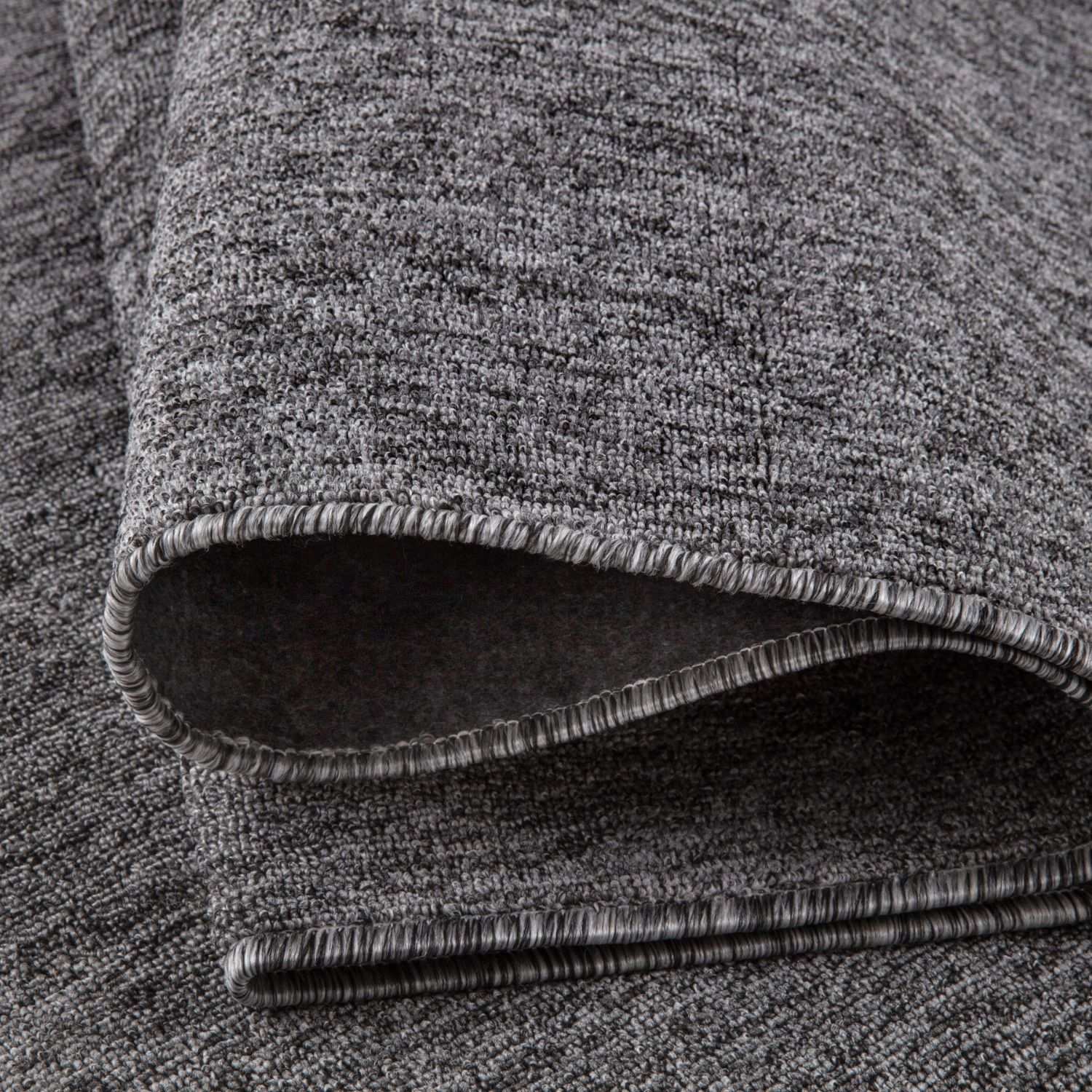 Gray low pile flex grey low rug with woven heathered texture and neatly finished edge for versatile floor use