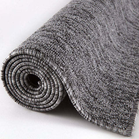 A plush flex grey low pile solid rug with a soft textured looped pile and neatly finished edges