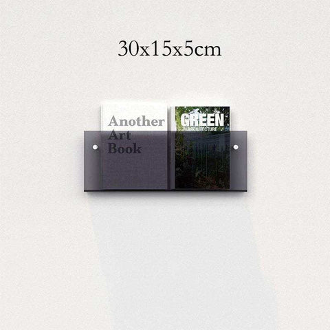 Dark gray translucent floating acrylic magazine holder mounted on wall holding two books in acrylic magazine holder style