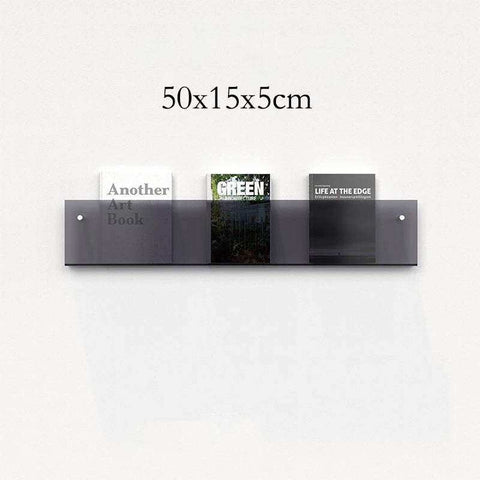 Modern minimalist floating acrylic magazine holder with three gray transparent acrylic compartments holding books