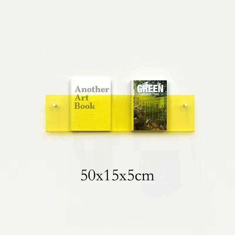 Bright yellow floating acrylic magazine holder wall-mounted with two slots holding different art books