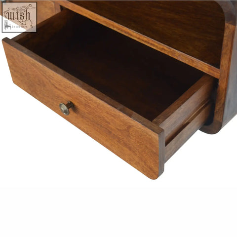 A warm brown wooden drawer with a rounded front and metal knob from a floating chestnut open console in solid mango wood