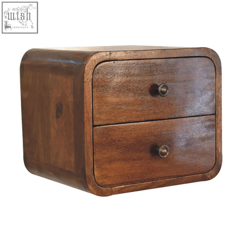 A rustic dark brown wooden floating mini chestnut bedside table with two drawers and round metallic knobs