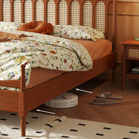 White circular robotic vacuum cleaner under the flora king size bed made of cherry wood king size bed frame
