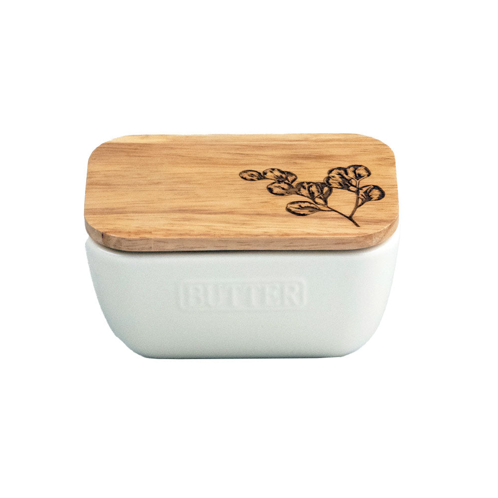 Flora white butter dish with a white ceramic base and bamboo lid engraved with a botanical design
