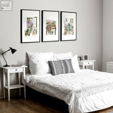 Black-framed floral art illustrated prints set of 3 hanging above bed perfect for country cottage wall decor