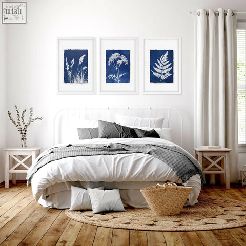 Woven wicker basket with sturdy handles on a round jute rug complementing floral art wall cyanotype indigo prints set of 3