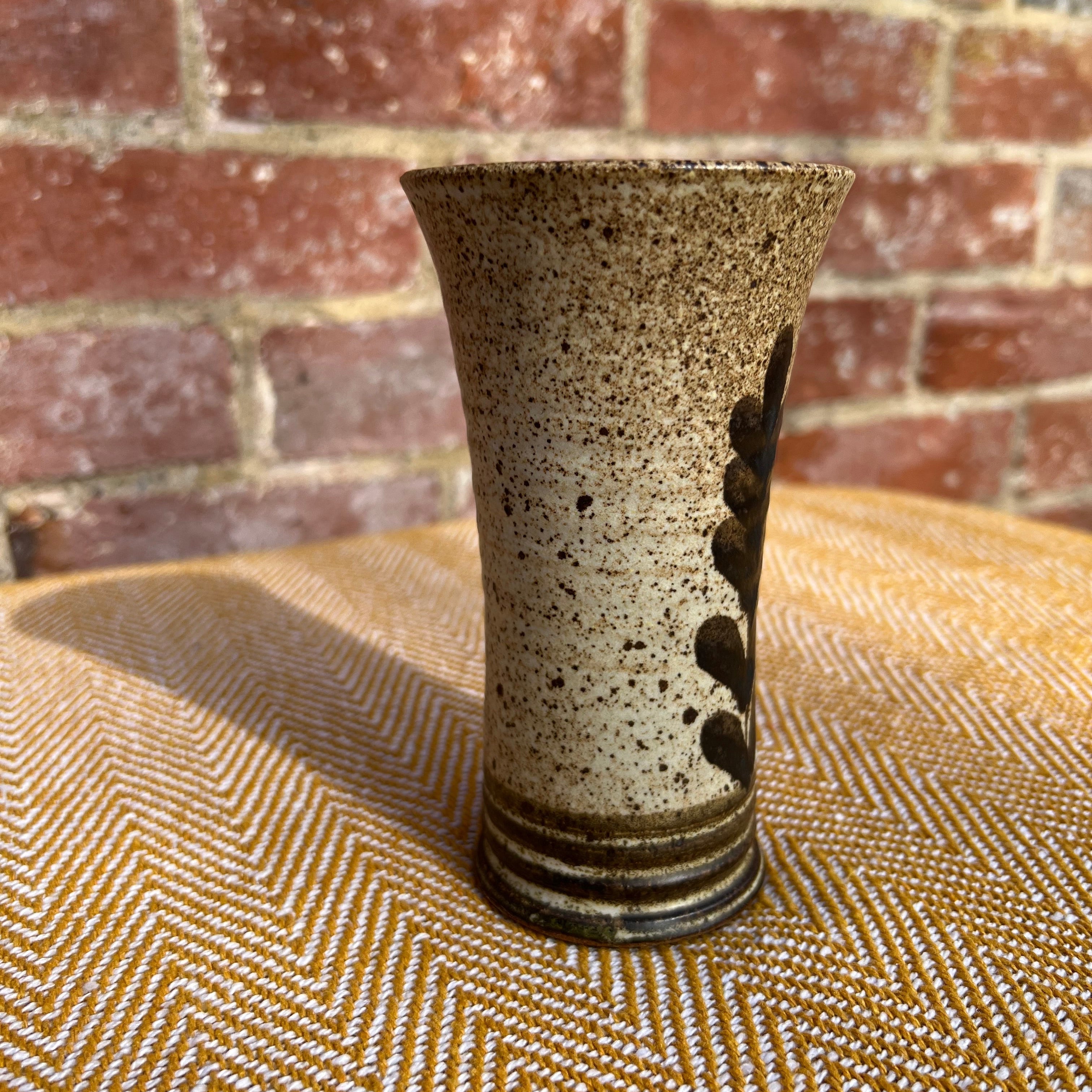 Floral ceramic vase with speckled beige finish dark brown leaf motif and ribbed base perfect for flowers