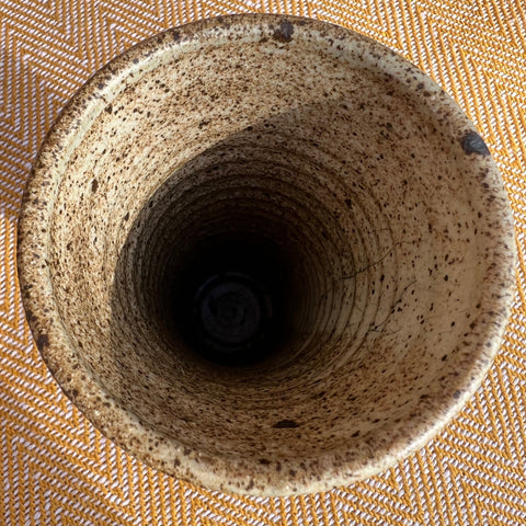 A speckled beige floral ceramic vase with a textured handcrafted finish and subtle brown flecks