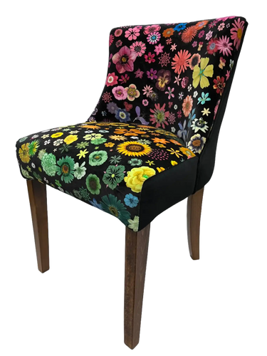Floral-patterned armchair with wooden legs and black upholstery.